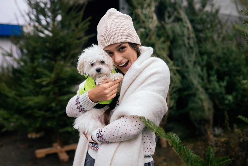 Beautiful young woman with a white dog